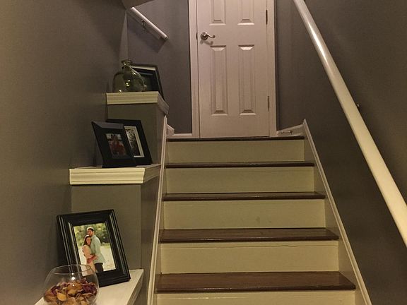 Stairwell from the front door leading to the living room. Co