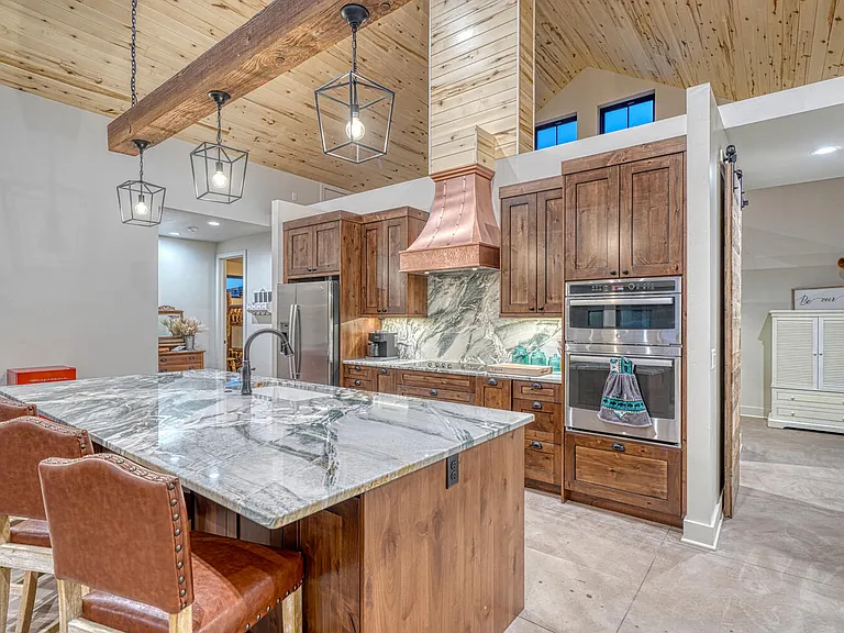 Pine ceiling and stunning Brazilian Quartzite counters polished off with the copper vent a hood. This amazing lodge is the perfect place for your visit to the Mount Princeton area.