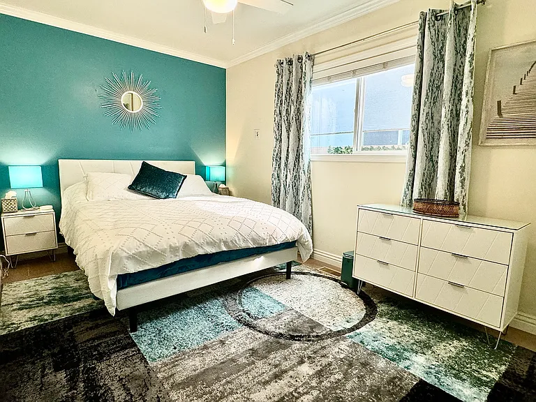 Downstairs bedroom with full mirrored closet, ensuite full bathroom with walk-in shower