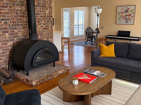 Living room with view to dining room. Wood burning stove