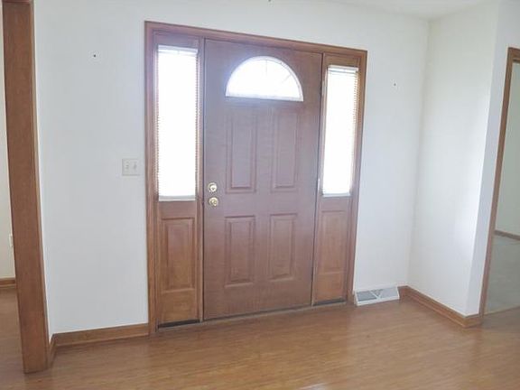 Front entry with side lights.