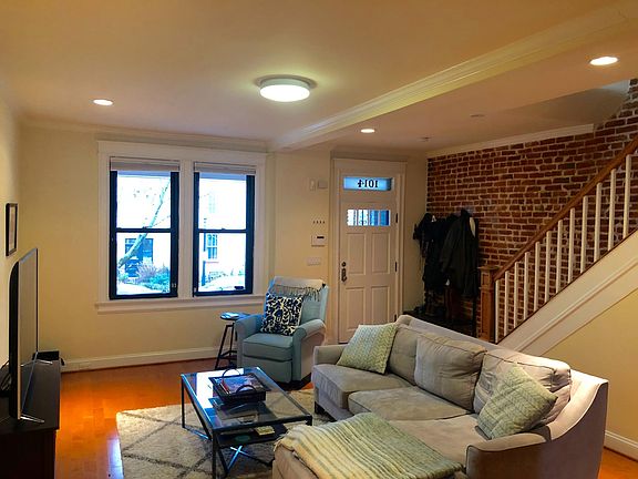 Open living room with exposed brick