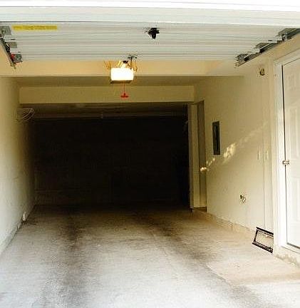 Large attached tandem garage with lots of storage space on the side for your sporting activities! There is also a faucet to attach a hose as needed.