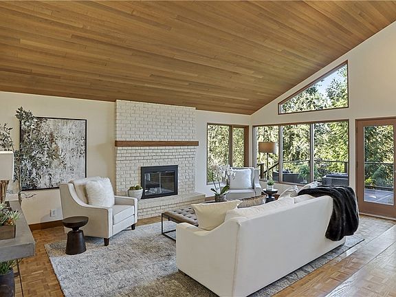 Soaring ceilings, walls of floor-to-ceiling windows & clean lines abound in this dramatic two-story home with daylight basement on 5.5 acres of private tranquility. 