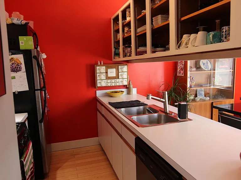 Kitchen with open cabinets. Rental comes with a fridge, gas oven and stove, dish washer, and sink disposal.