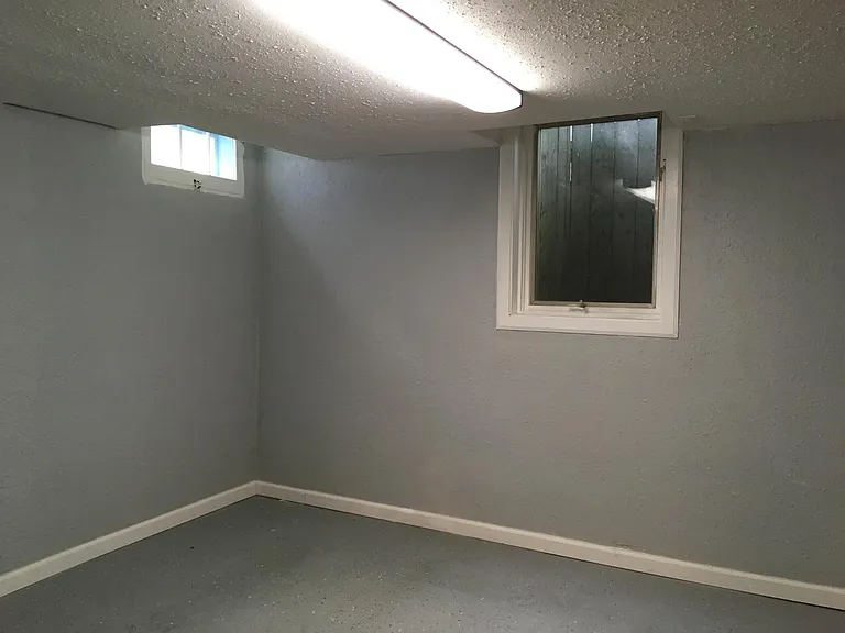 Bonus room in the basement at the bottom of the stairs.