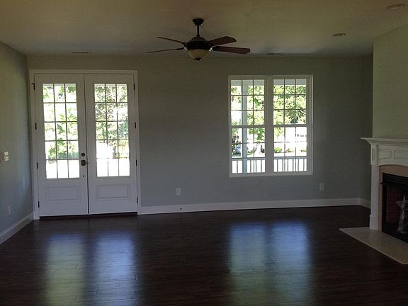 Standing at stove your view of the living room . The paint is a blue/gray color through out the house .