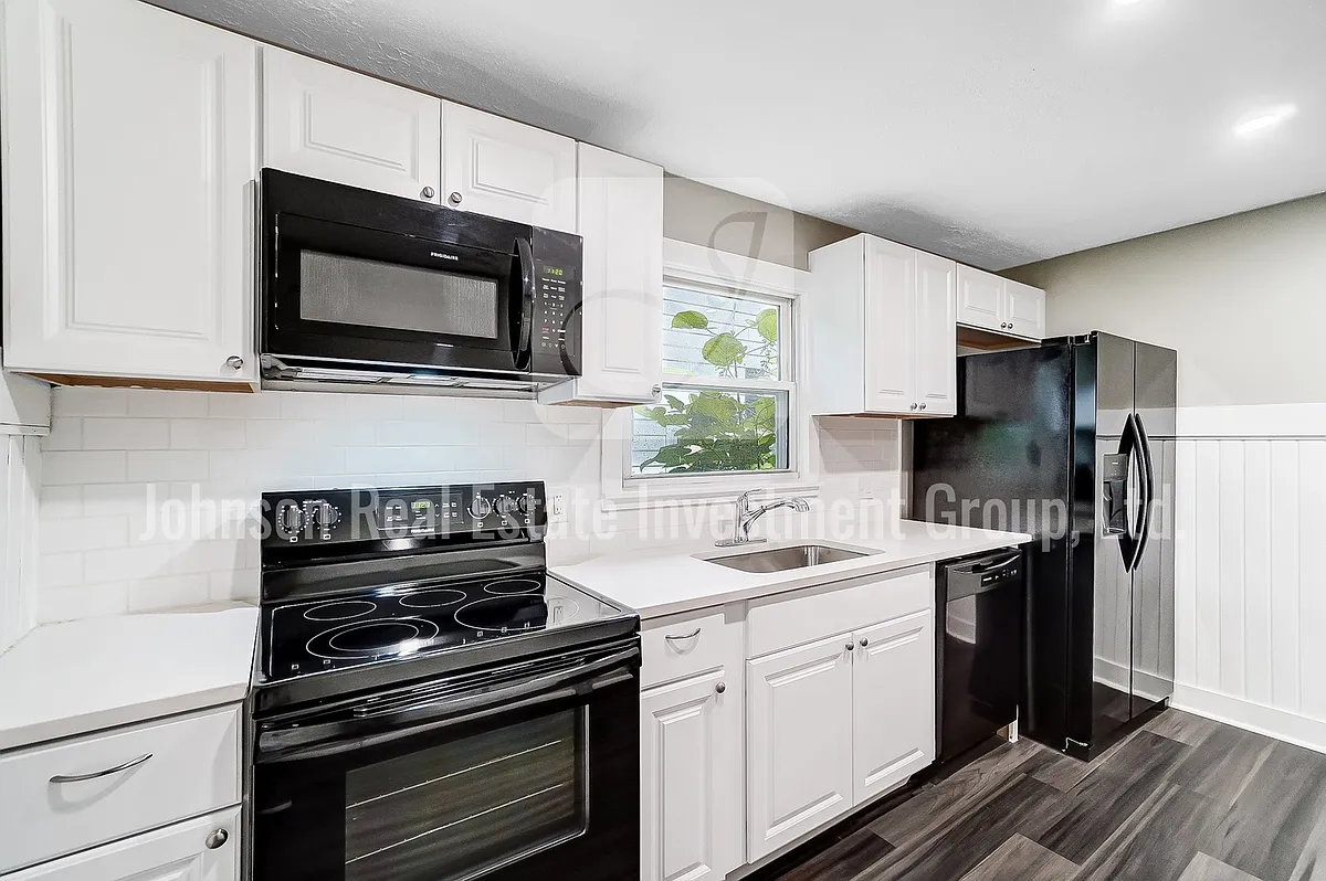 Stunning remodeled kitchen with black appliances and white quartz countertops! - 1911 Henry Ave