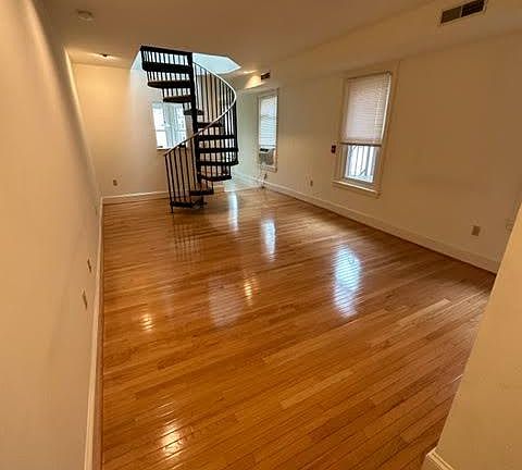 Living room with spiral staircase to bedrooms upstairs