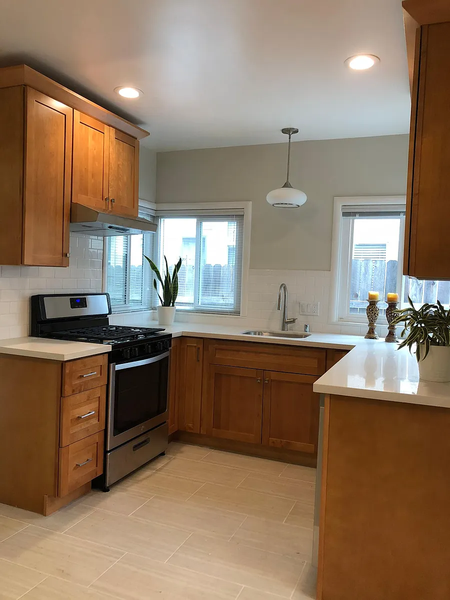Beautifully renovated in 2018, kitchen has tile flooring, maple shaker cabinetry, stainless steel appliances including gas stove, dishwasher and refrigerator. Quartz counter top, white subway tile backsplash, natural light through two corner windows. - 2140 11th Ave