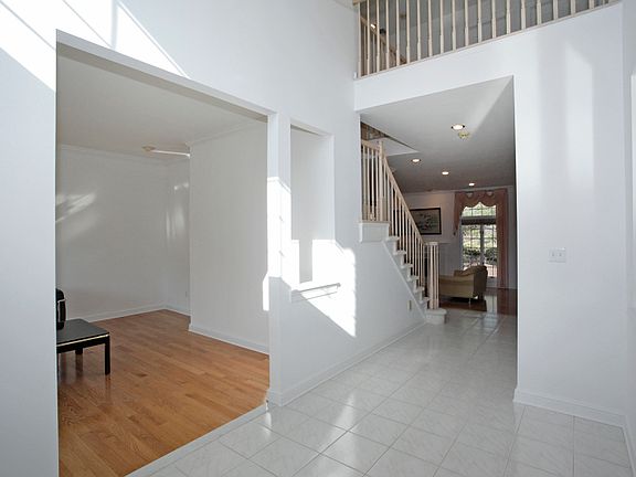 Tile 2-story foyer opens to the living room and separate dining room.