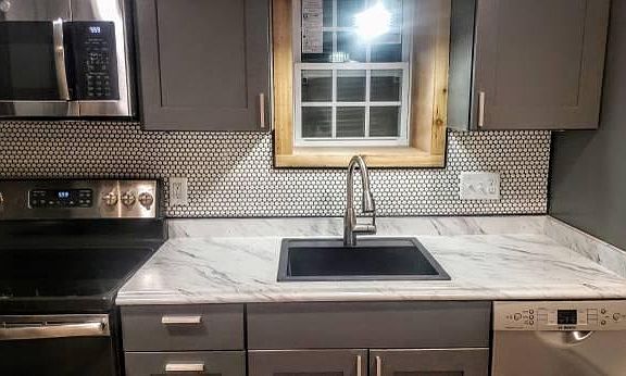 Close-up of countertop and tile backsplash.