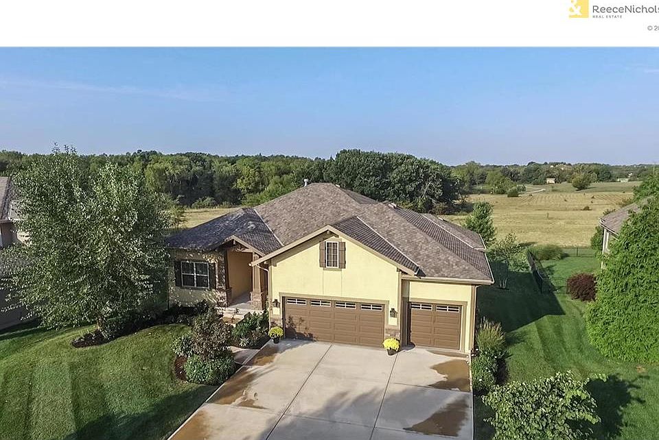 Lovely Reverse 1.5 story home, backs to acres of open land and Iron Woods Park.