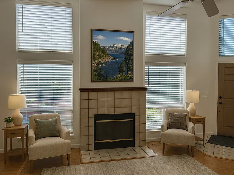 Living room fireplace with windows that face the river and greenbelt.