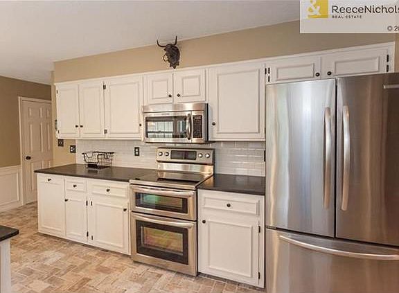Added on extra cabinets including trash bin. High end granite counter tops!