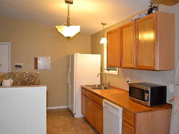 The kitchen was opened up. Oak cabinetry and a tile floor were added.