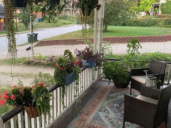 Covered front porch. Patio furniture can stay.
