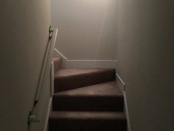 Stairs to lower level laundry, family room, bedroom and bathroom.