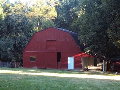 Barn with water and power has housed chickens, a pig or two, and other animals over the years. Fully fenced grazing pasture in front of barn.