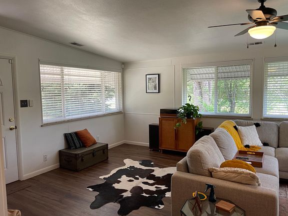 Large living area with wrap around the room windows.