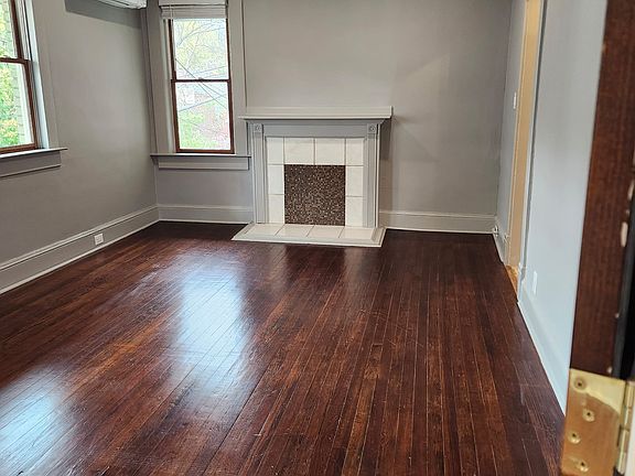 Living room featuring decorative fireplace and recessed lighting.