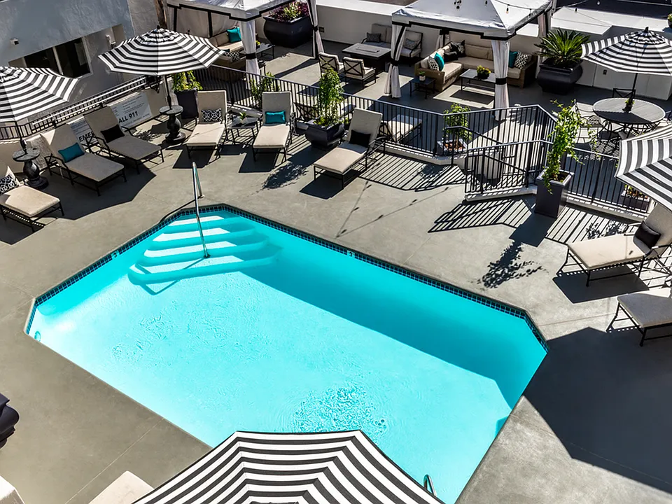 Take a refreshing dip or unwind on comfortable lounge chairs beside the outdoor swimming pool.