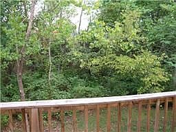 The back porch looks out onto woods.