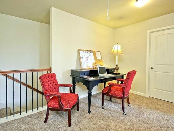 This photo is representative of a McPherson plan second floor Loft with Iron rail upgrade accent