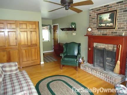 This brick two story sits on a wooded corner lot.