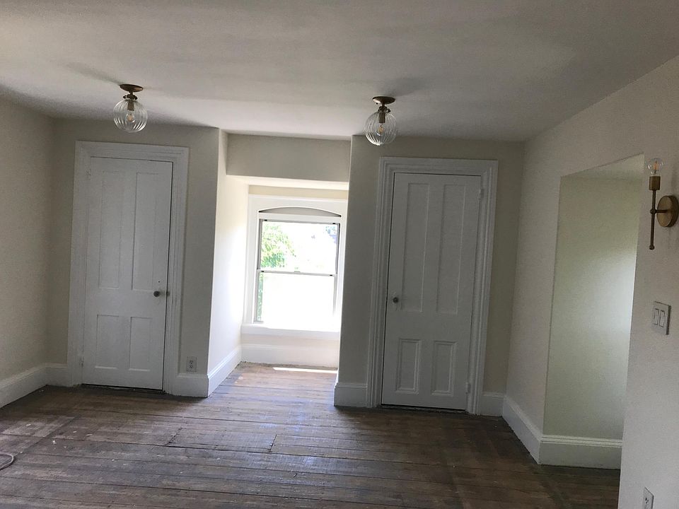 Living room full of natural sunlight boasts two nice closets