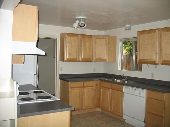 Roomy well lit kitchen with plenty of cabinet space.