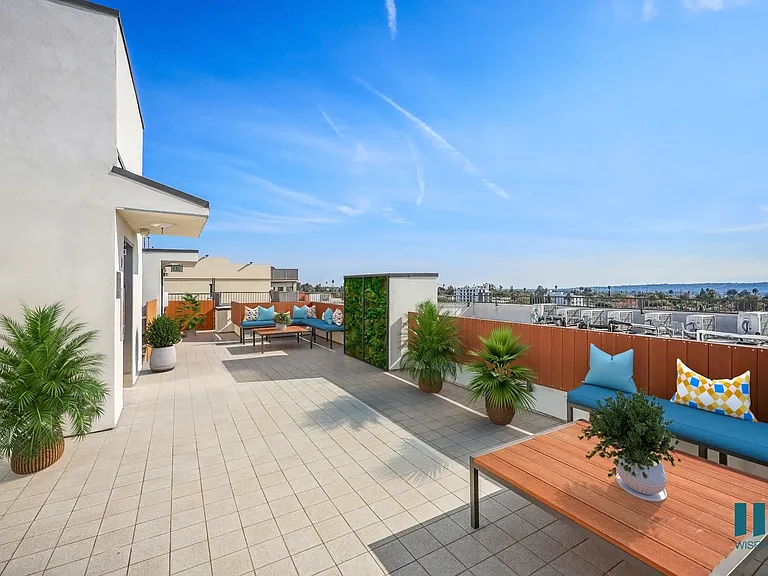 Rooftop Deck with Entertainment Space and Views of the City