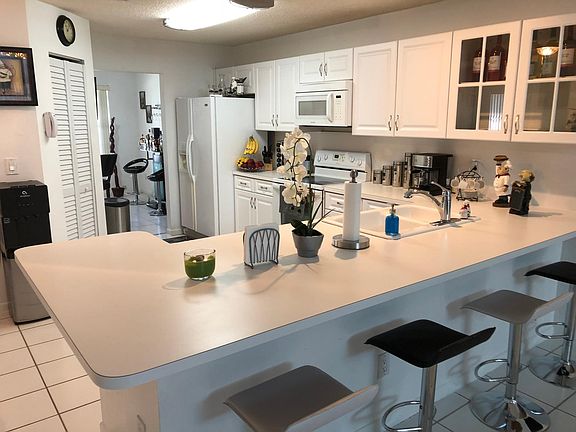 Spacious & bright white kitchen has large pantry. Granite co