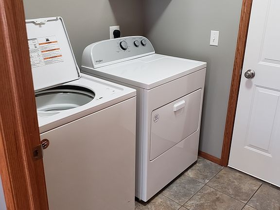 Separate laundry room that includes both washer and dryer