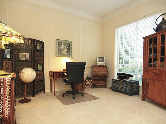 DEN/FORMAL LIVING ROOM- This sun filled room has gorgeous crown moldings, neutral colors and the ability to be used for an office, formal living area and really anything else you can think of!