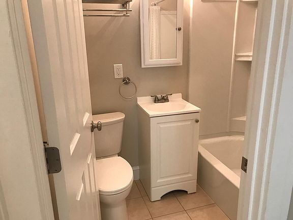 Bathroom off of kitchen next to second bedroom