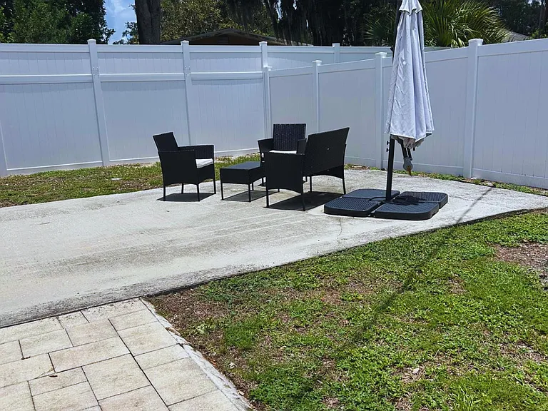 Charming outdoor seating area with umbrella, perfect for relaxing.