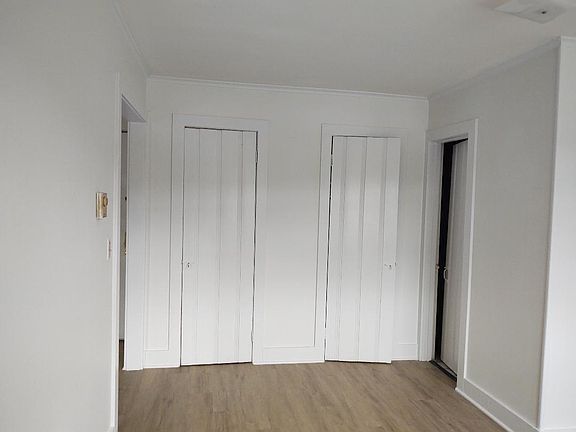Bedroom facing closets and bathroom