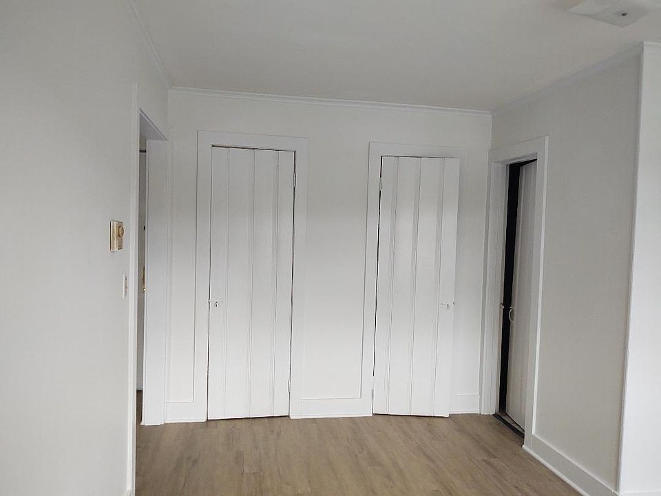 Bedroom facing closets and bathroom