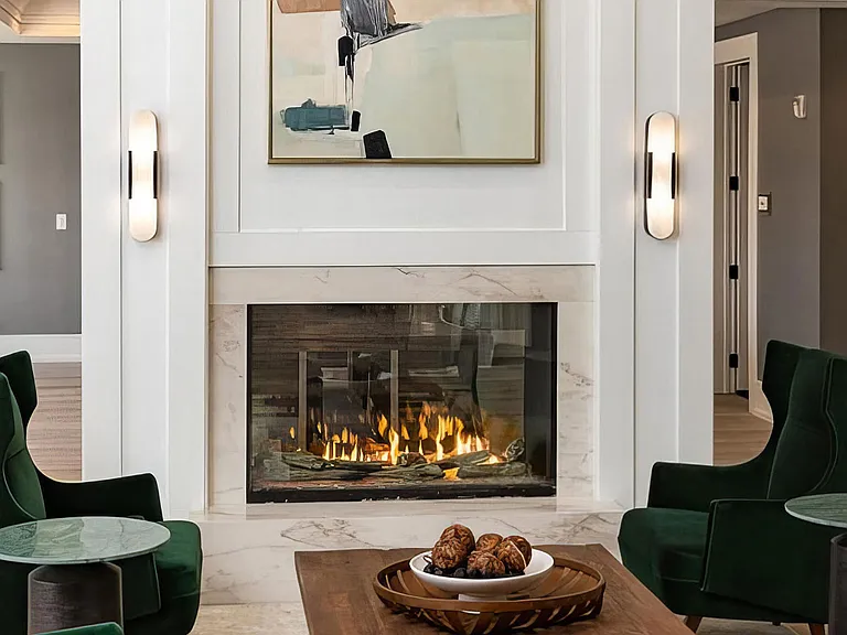 Sophisticated Lounge with Fireplace, Velvet Chairs, and Abstract Art