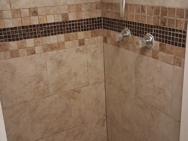 Lower floor stand up shower in bathroom.