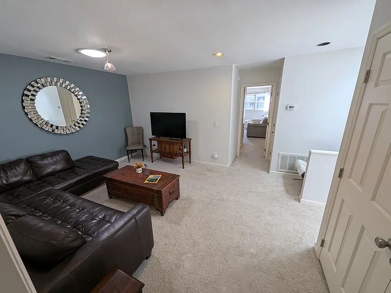 Living room facing entryway to office/second bedroom
