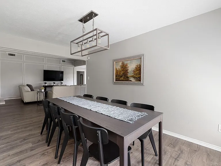 Dining room with LVP floors and a chandelier