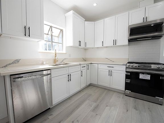 Newly renovated kitchen with all new stainless appliances (still with the plastic), floors, and cabinets.