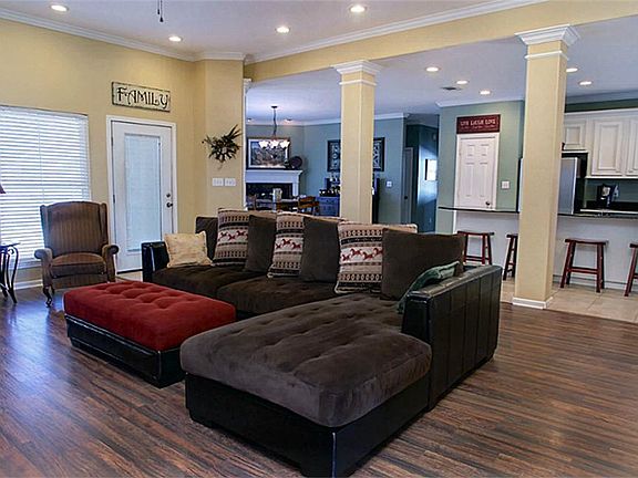 This living room is beaming with Style! Enjoy the gleaming wood floors, crown molding, recessed lighting, and gorgeous view of the Sparkling Pool in back.