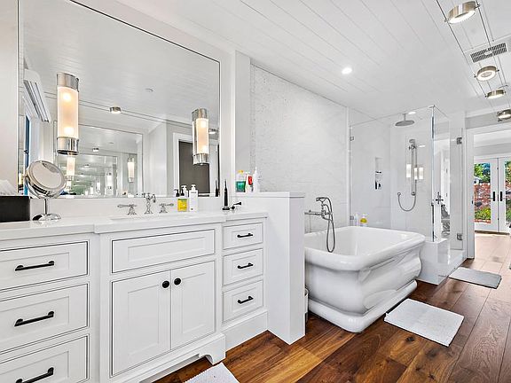 Main floor master bathroom with large tub and separate shower.
