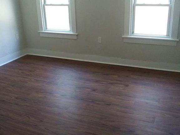 Newly painted living room with new floors ready for furniture.