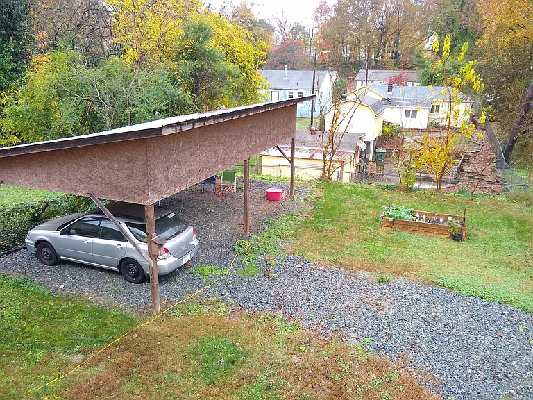 Back yard, spacious carport & covered sitting area