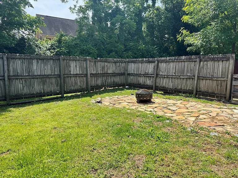 Fenced area for pets and fire pit fun.