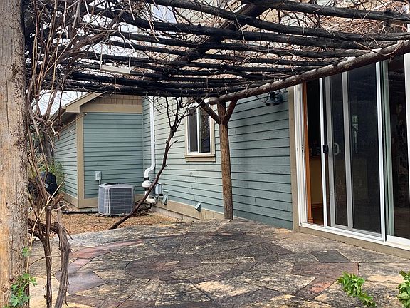 Back porch with grape vine wrapped pergola.